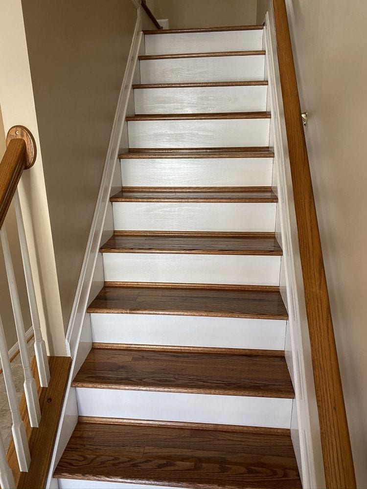 Finished staircase with stained wood treads, white painted risers, stringer and handrail.