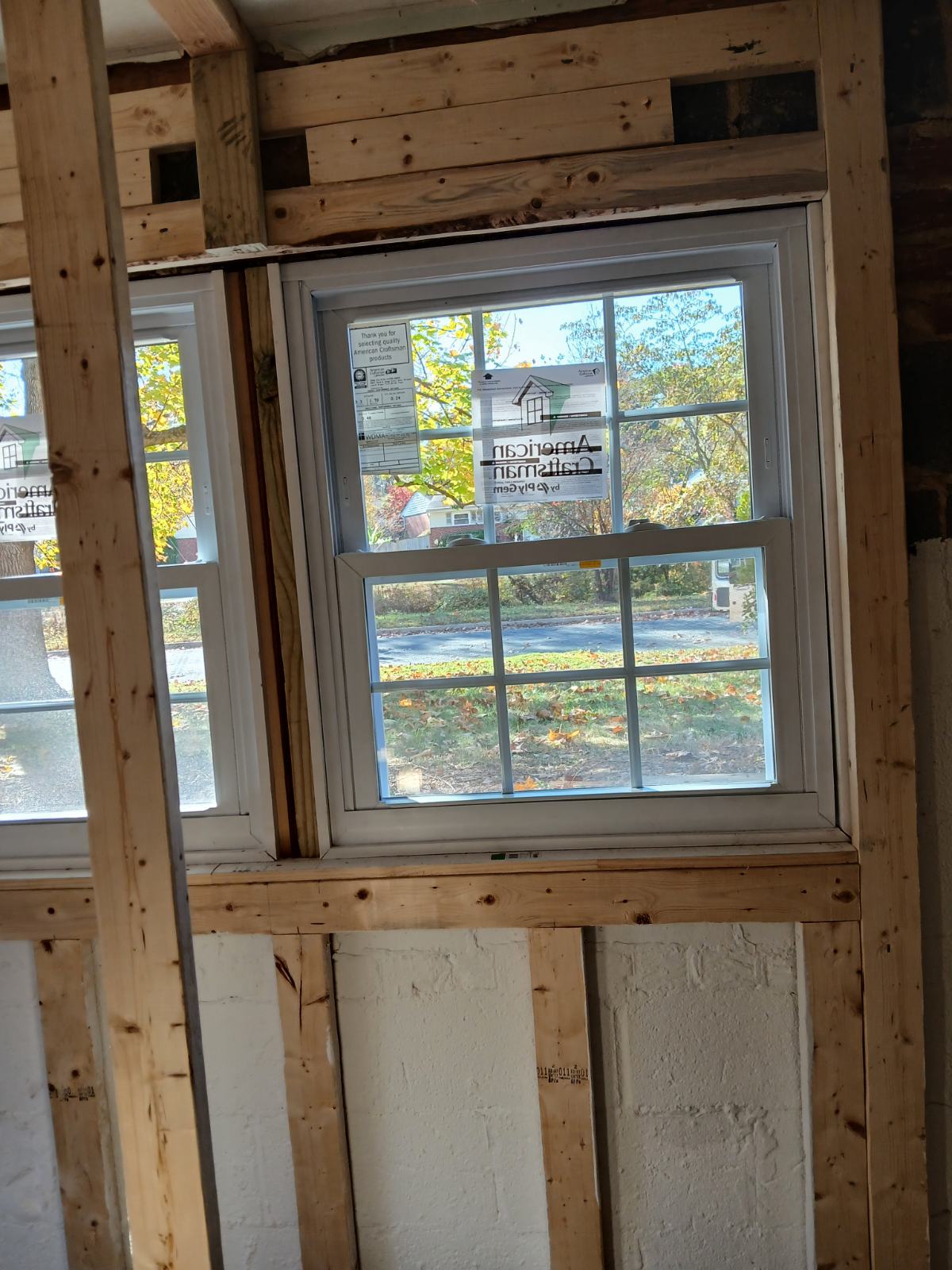 New window installed in an exposed timber wall opening before the interior trim is fitted.
