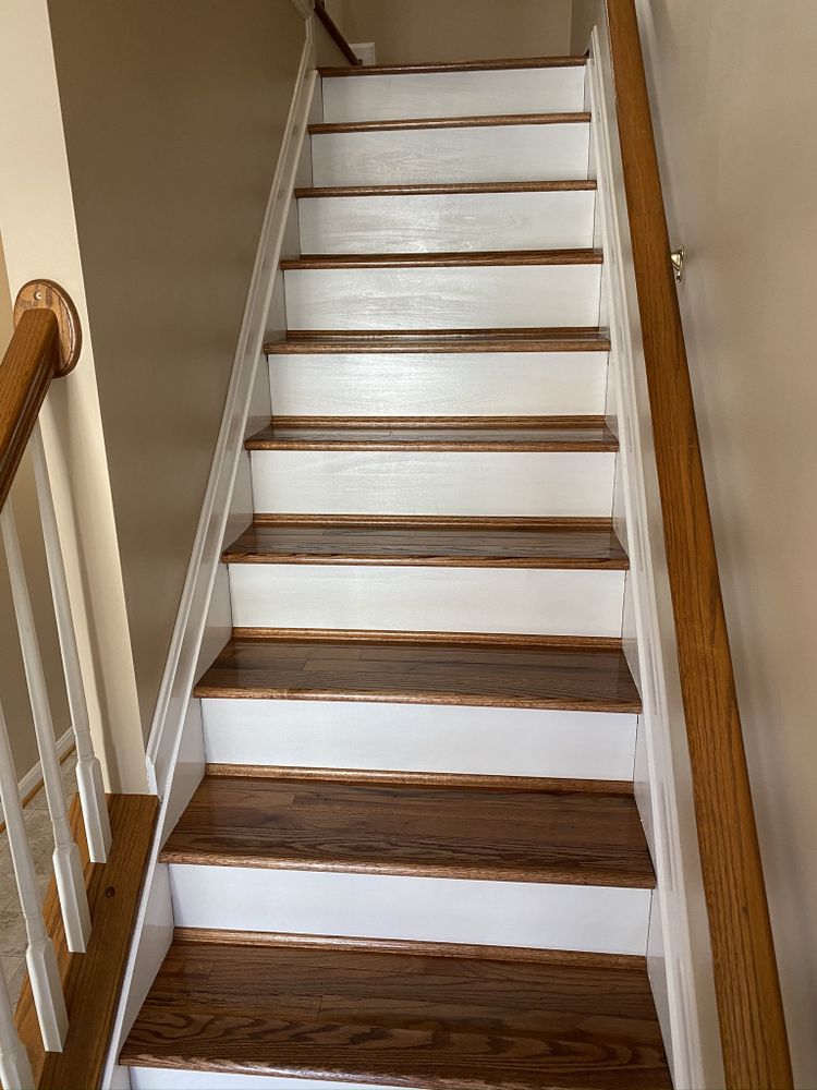 Finished staircase with stained wood treads, white painted risers, stringer and handrail.